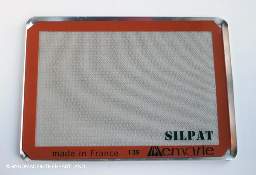 silpat nonstick baking liner sitting on a metal perforated baking sheet