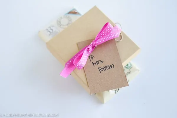 handmade polymer clay earrings packaged in a gift box tied with a ribbon to a chocolate bar