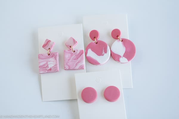 pink and white marbled polymer clay earrings on white earring cards