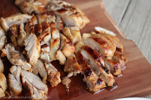 sliced chicken thighs on cutting board