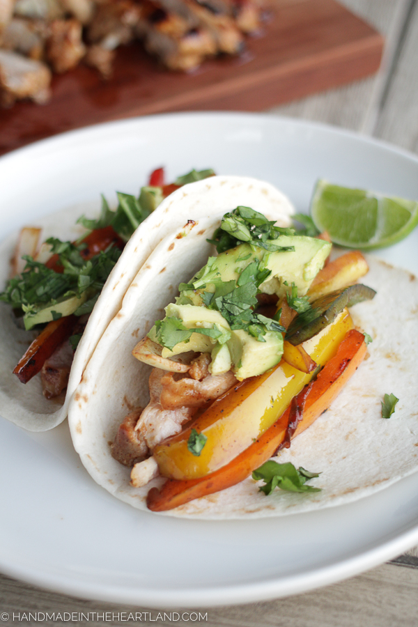 chicken and veggie fajitas tacos on white plate