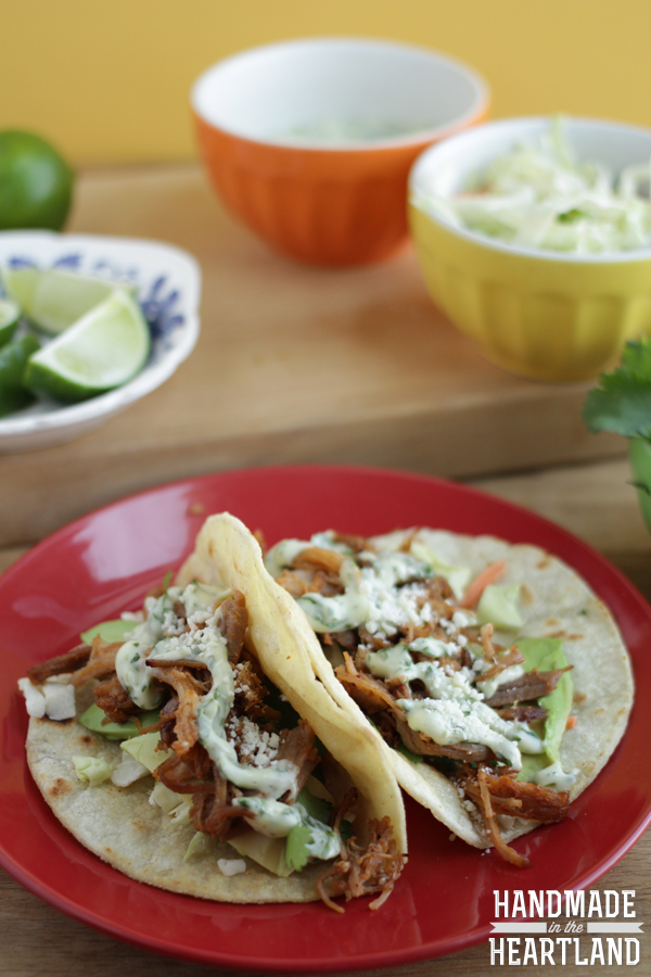 delicious and easy to make crock pot pulled pork tacos with cilantro lime aioli