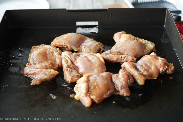 chicken thighs being cooked on a Blackstone Griddle
