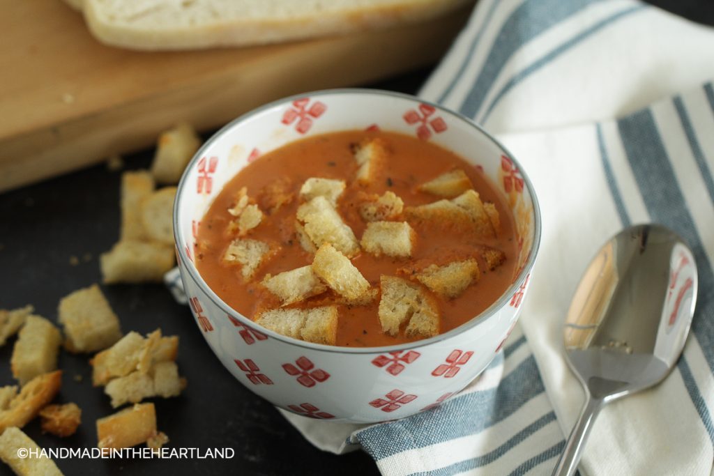 Tomato soup with parmesan croutons in a bowl