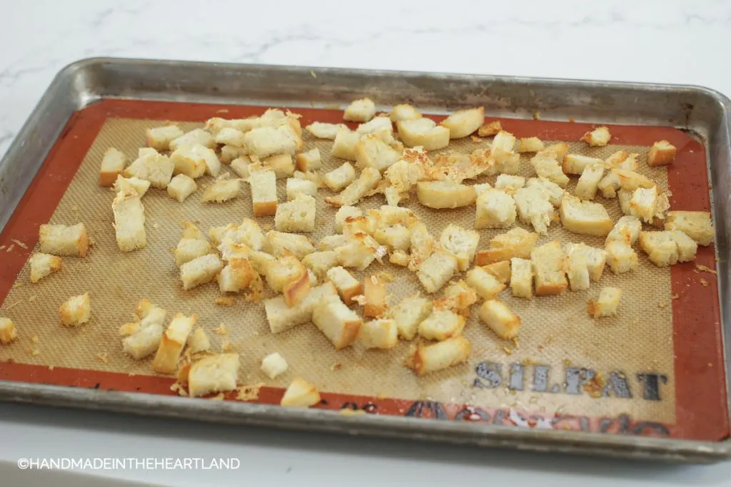 diced sourdough bread slices after coming out of the oven, now are croutons for soup