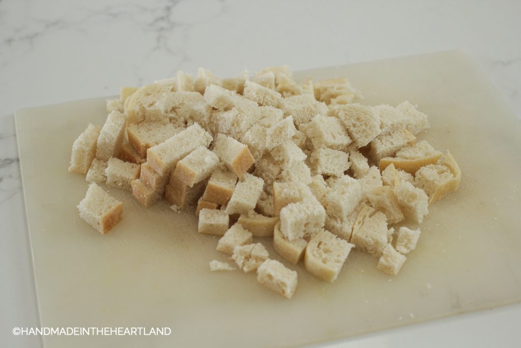 diced sourdough bread on a cutting board