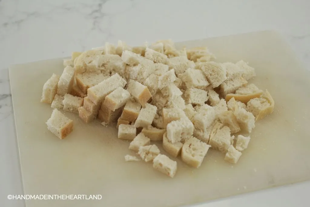 diced sourdough bread on a cutting board