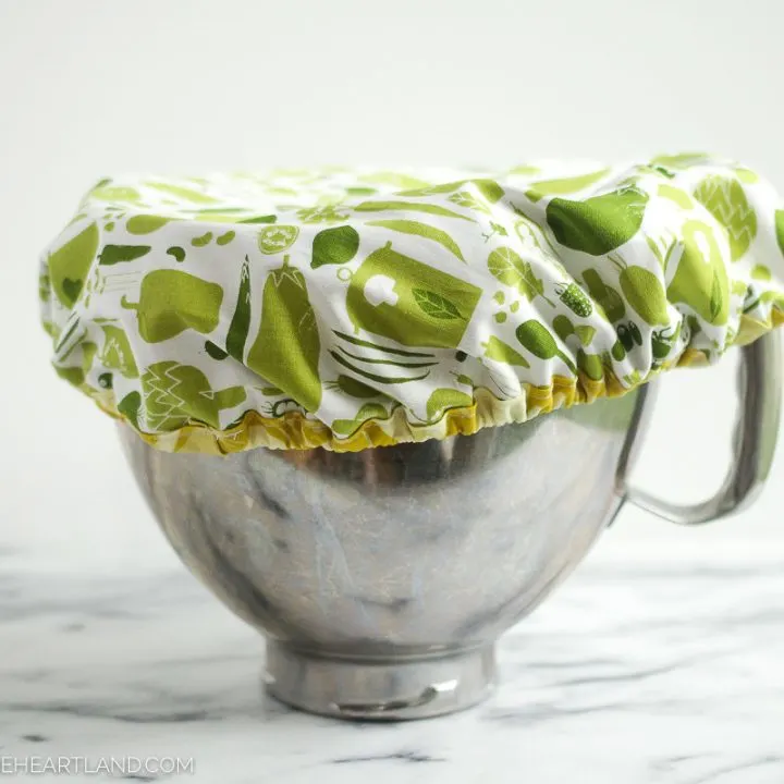 A stand mixer metal bowl covered with fabric elastic mixing bowl cover