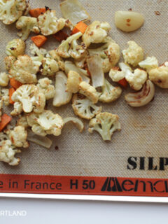 roasted cauliflower and carrots on a Silpat nonstick baking liner