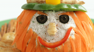 Cheeseball appetizer decorated to look like a leprechaun
