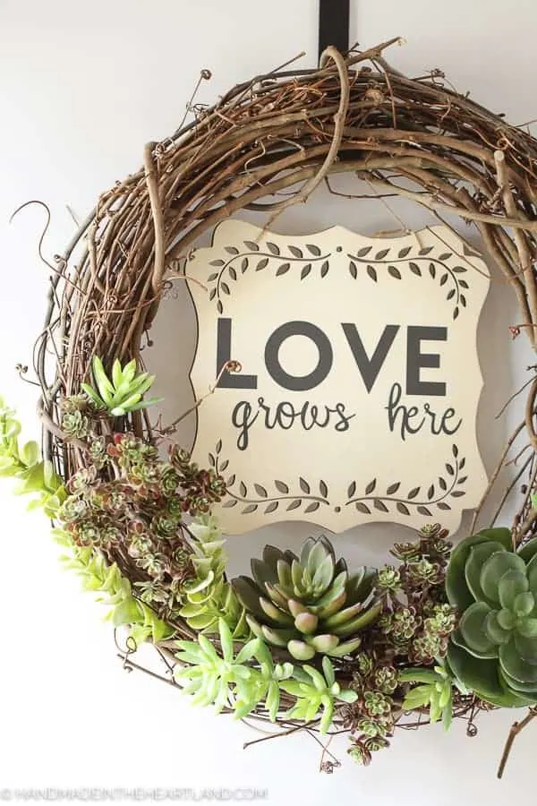 grapevine wreath with faux succulents on the bottom and 