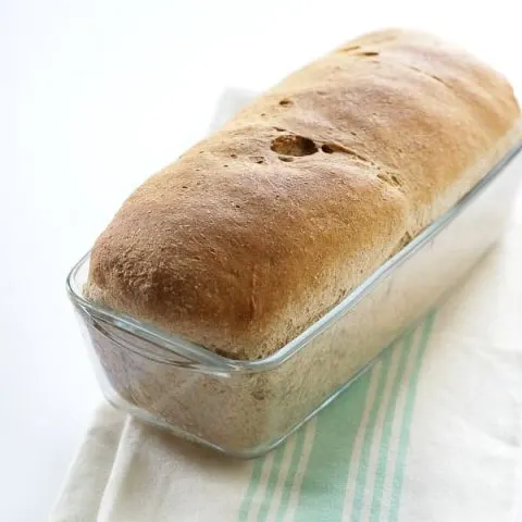whole wheat bread in a glass bread pan