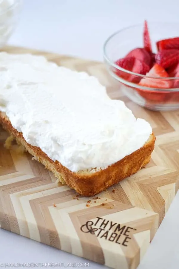 whipped cream layer on top of strawberry shortcake cake