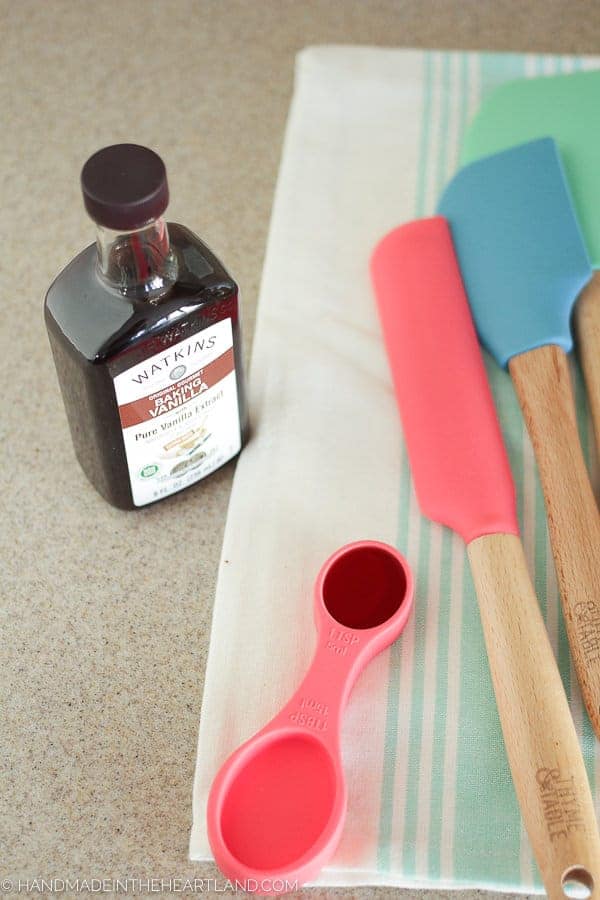 Measuring vanilla extract for strawberry shortcake cake