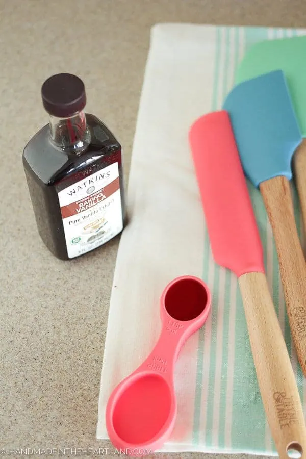 Measuring vanilla extract for strawberry shortcake cake