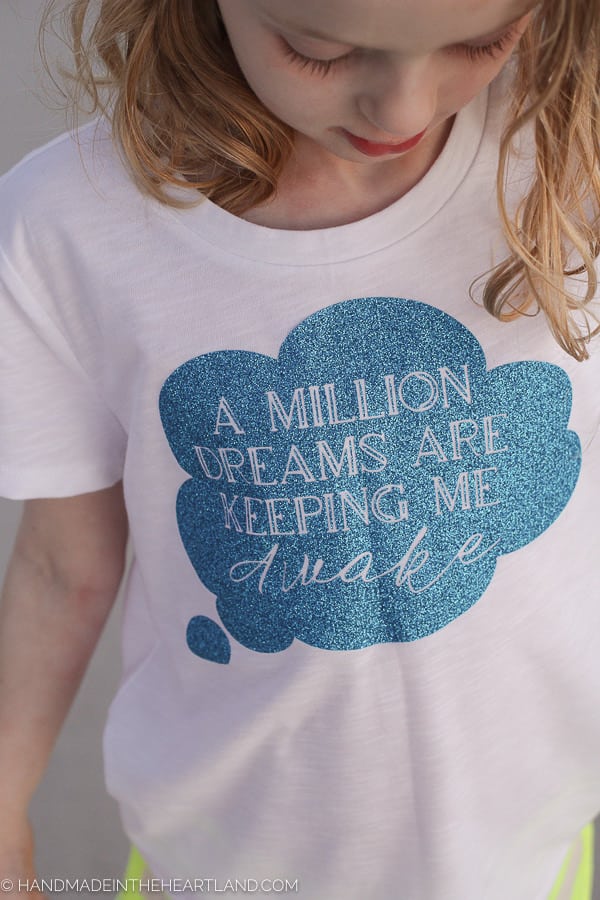 Little girl wearing DIY tshirt with quote "A million dreams are keeping me awake" from The Greatest Showman movie, DIY Greatest Showman T-shirt