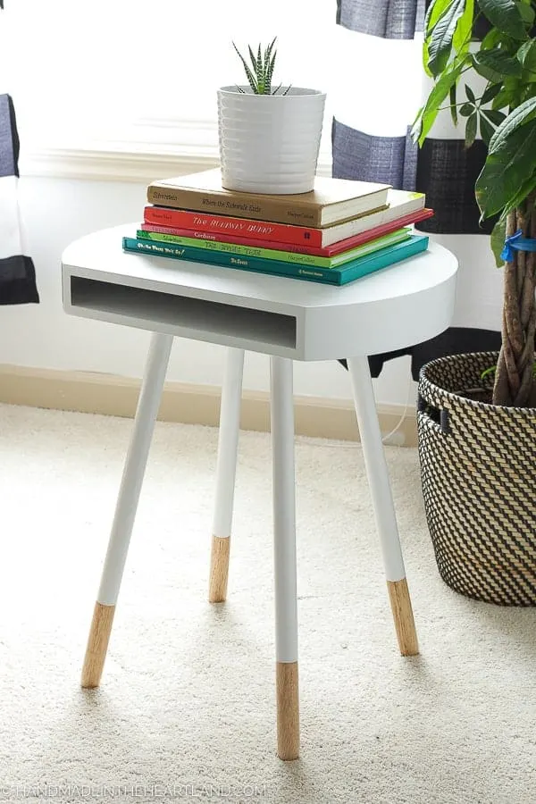 mid century modern end table with books style in a modern kids room
