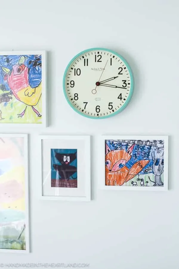 fun aqua clock and white frames purchased at walmart decorating modern kids room