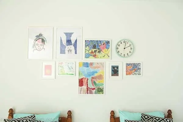 white walls with kids framed artwork in a modern kids room