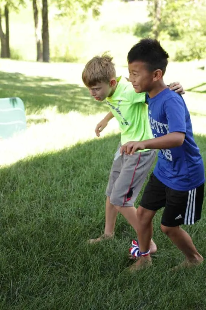 Image of 2 boys doing a three legged race