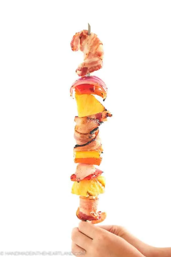 Image of kabob sticks with bacon wrapped shrimp and veggies. 