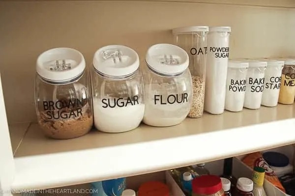 Image of pantry stapes like flour and sugar labeled in clear plastic containers