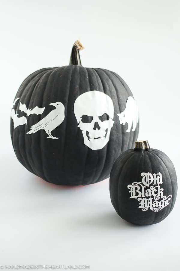 Black painted pumpkin with white vinyl stickers to decorate