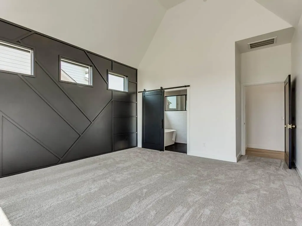 Tricorn Black accent wall and barn door in master bedroom, modern farmhouse paint colors