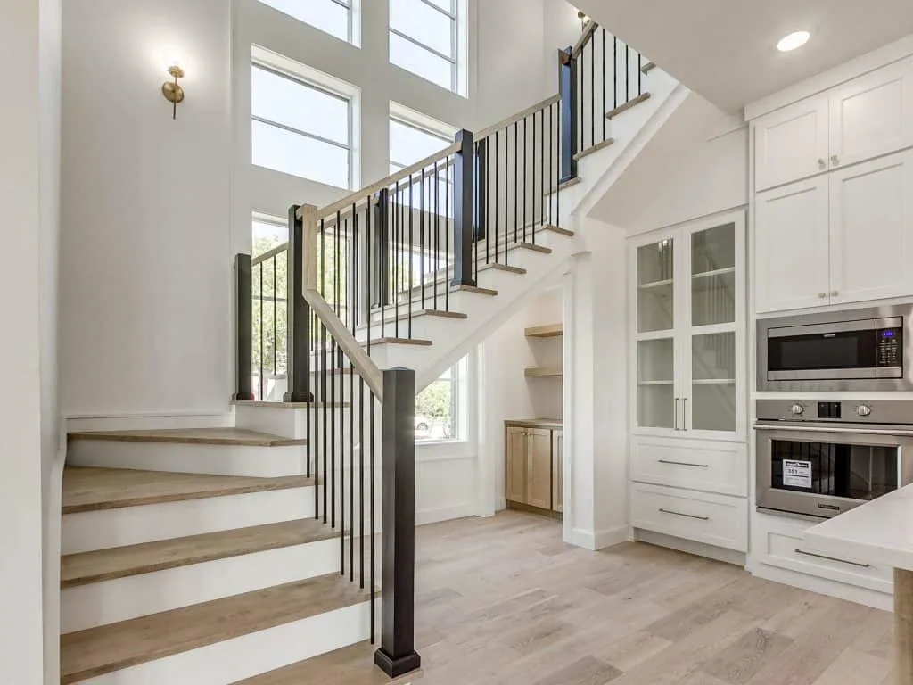Stairwell and part of the kitchen with pure white painted walls