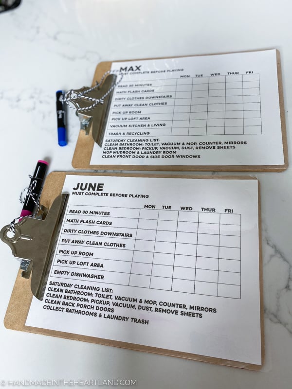 Laminated chore charts on clipboards for kids