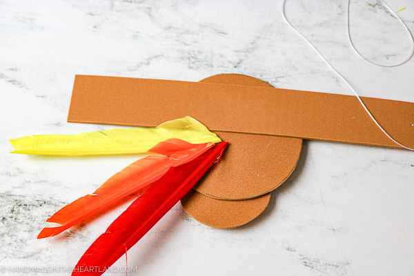 glueing feathers to back of turkey craft