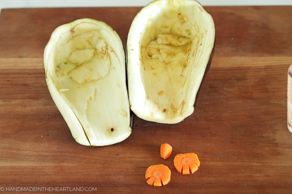 a hollowed out eggplant which will work as the body for the penguin and carrot pieces in the shape of feet and a beak for the penguin cheeseball