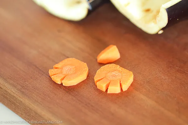 carrot slices cut into feet and a beak for the penguin cheeseball decorating
