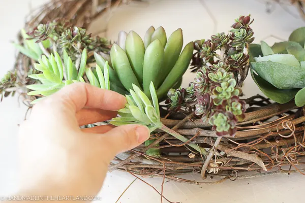 sticking stems into grapevine wreath