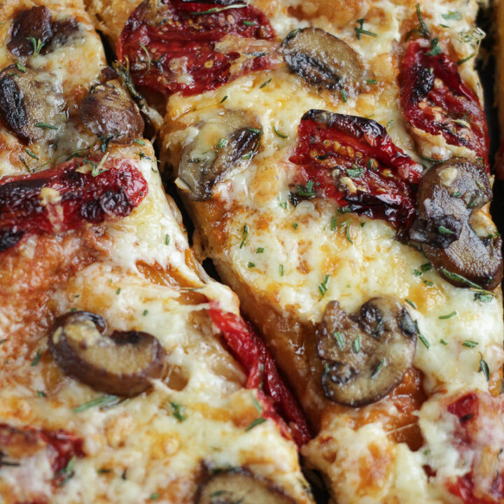 slice of pizza with mushrooms and sun-dried tomatoes