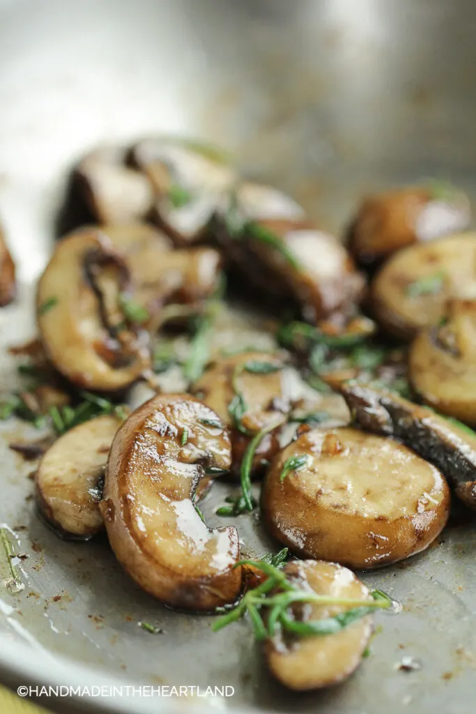 Mushrooms, Garlic and rosemary sitting in a saute pan after cooking
