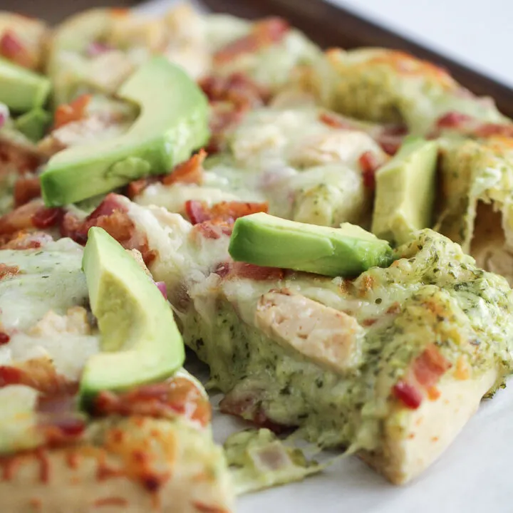 Pizza with chicken, bacon, ranch and avocado on top