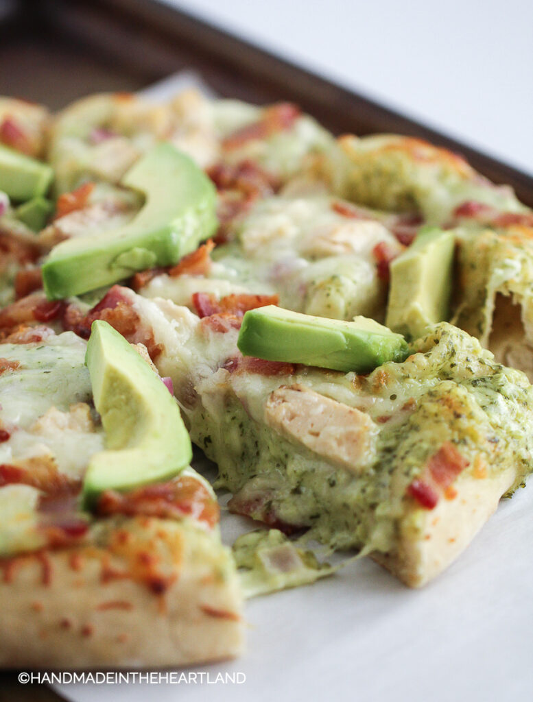 Pizza with chicken, bacon, ranch and avocado on top