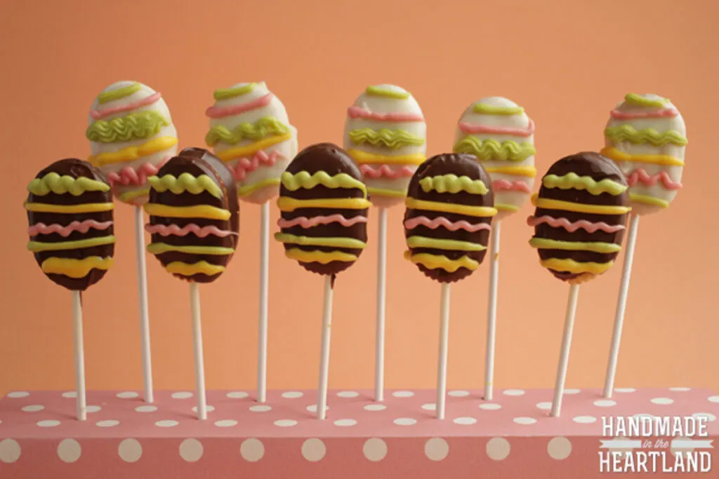 White chocolate covered Easter egg crackers and milk chocolate easter egg crackers standing up on sticks