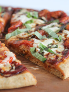 Homemade Caprese Pizza on wood cutting board