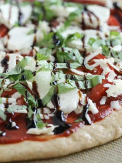 Pizza with fresh mozzarella and balsamic glaze before cooking