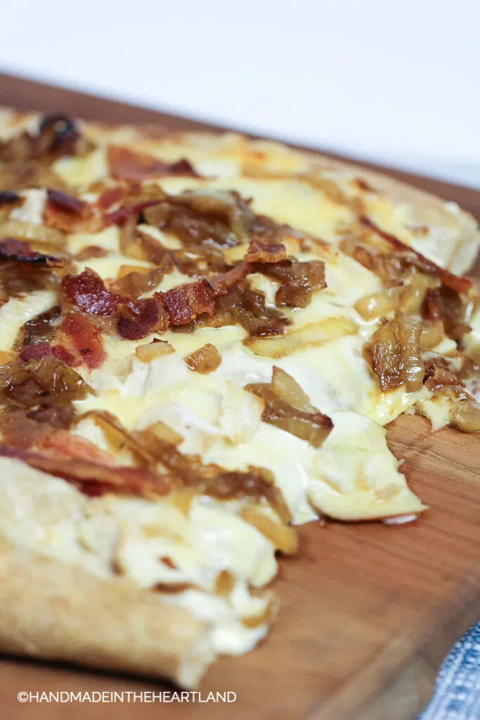 homemade pizza with melty cheese sitting on cutting board