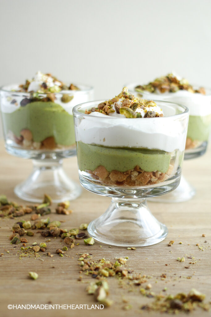 3 individual parfait cups layered with pistachio pudding, vanilla wafers and whipped topping