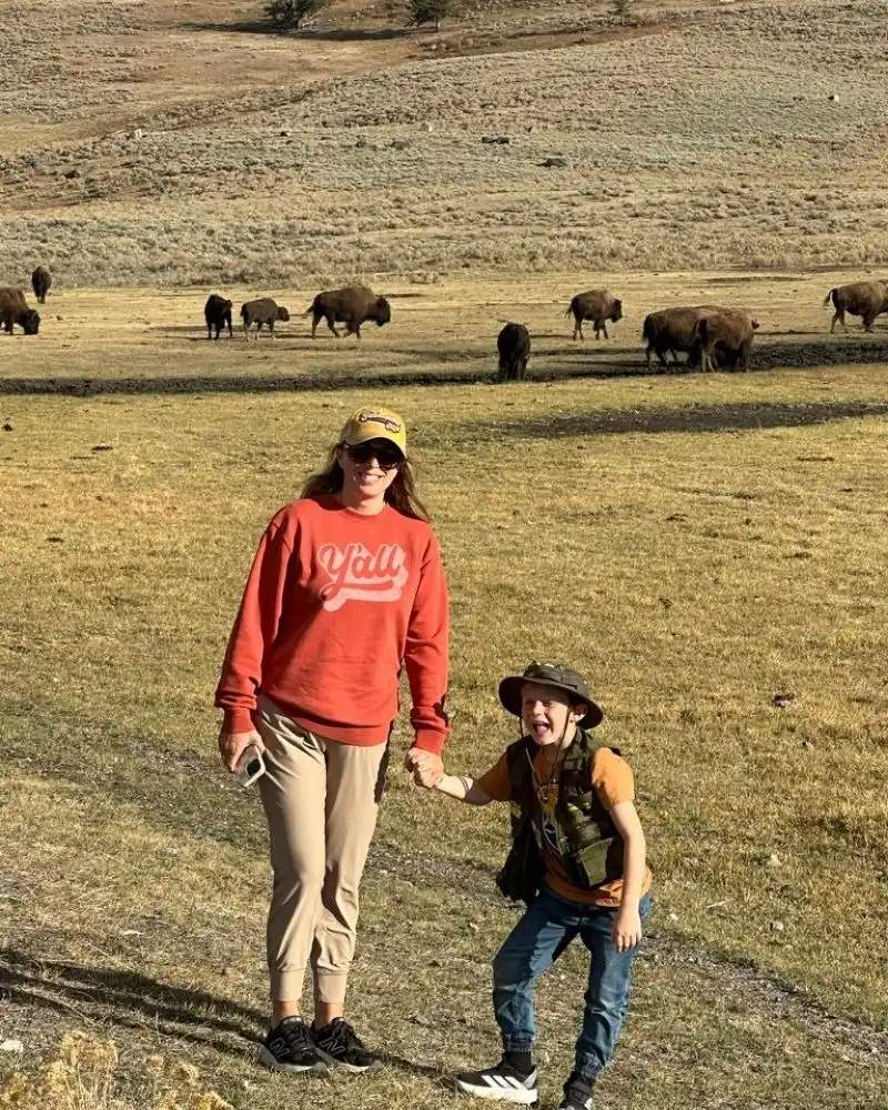 Mom and son in front of a herd of buffalo in Yellowstone