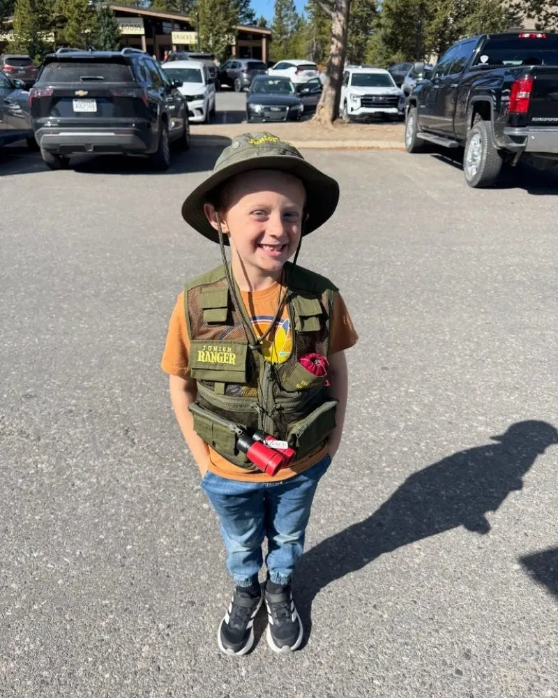 Young boy in a junior park ranger outfit at Yellowstone national park