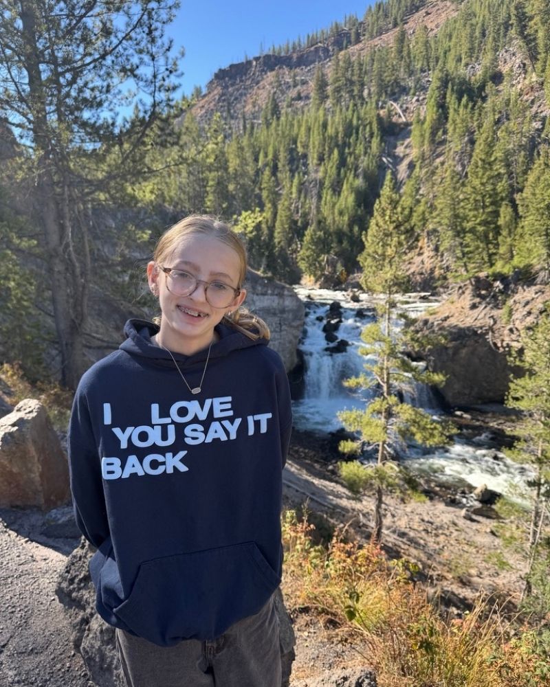 13 year old girl standing in front of fire hole falls in yellowstone national park